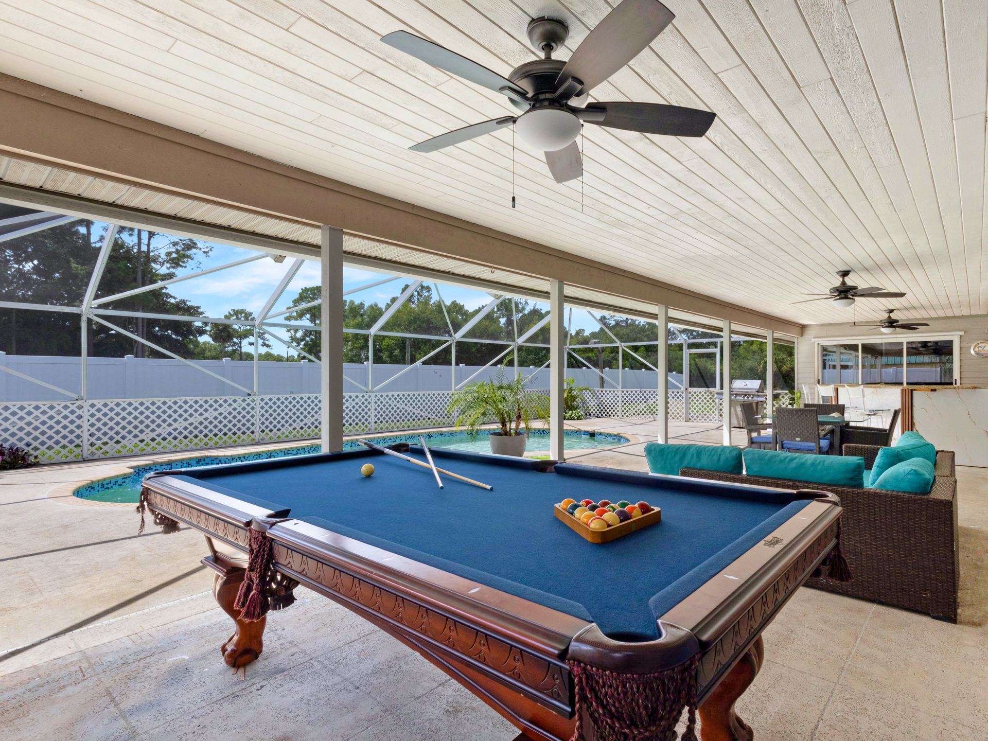 Billiard table on covered patio with pool view