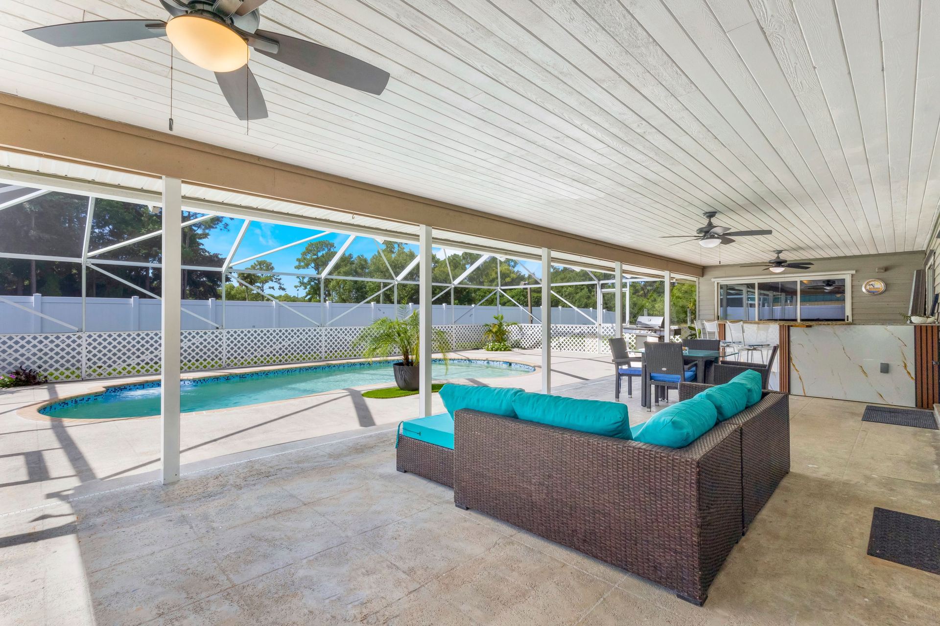Covered outdoor living area with pool view