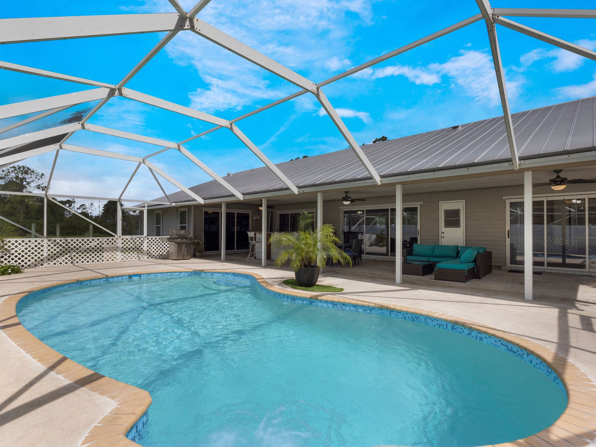 Private screened pool with patio seating in West Palm Beach