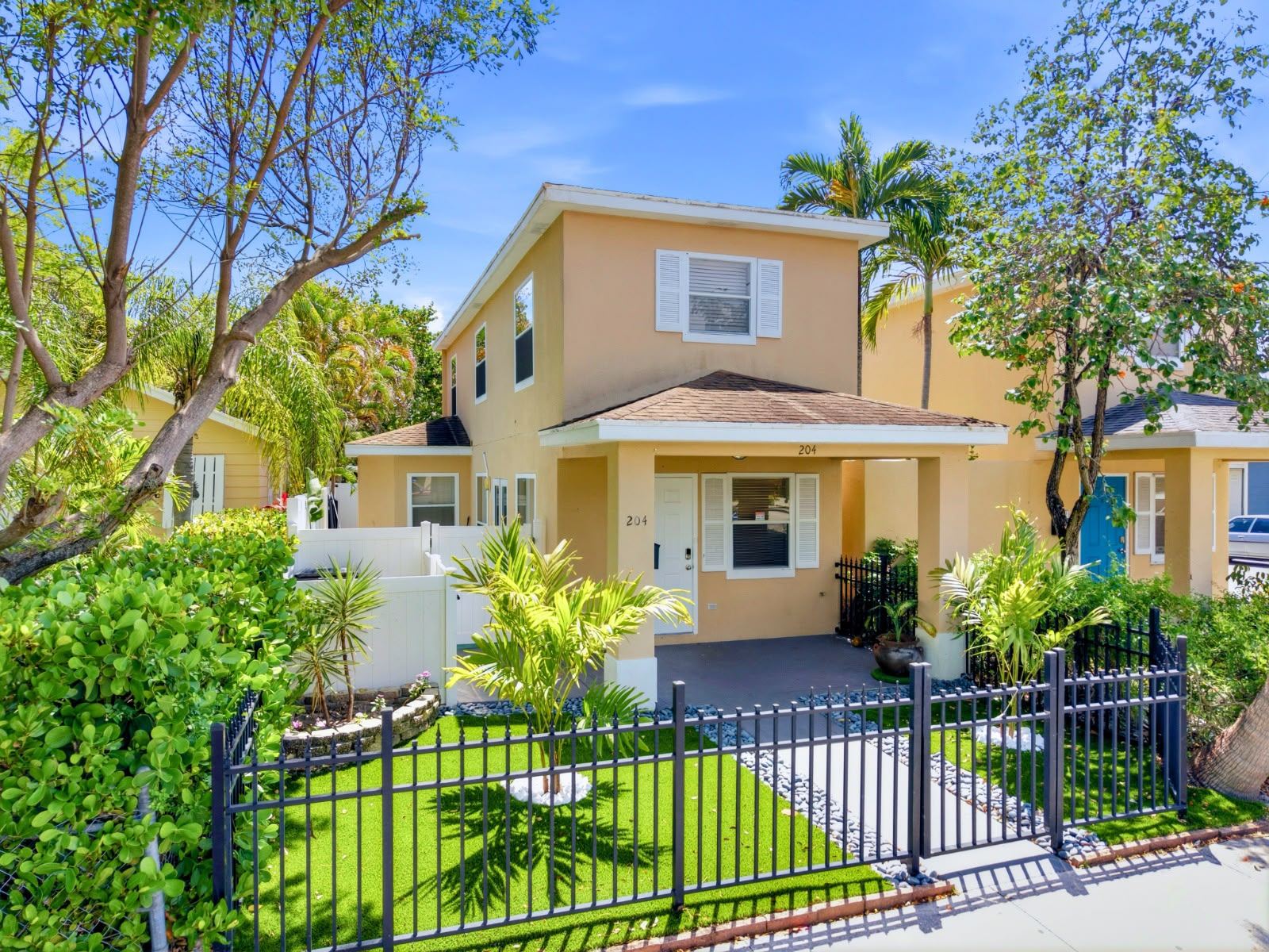 Front door and tropical garden of Lake Worth Beach vacation rental