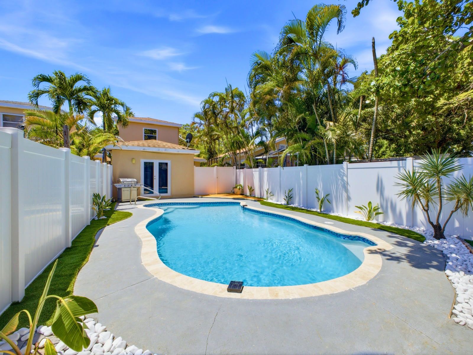 Private pool surrounded by palm trees in Lake Worth Beach